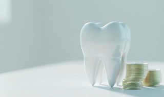 Large shiny AI tooth next to a pile of coins on a white surface with white background