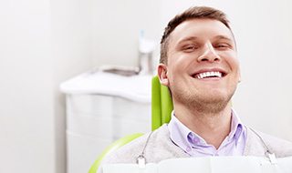 Smiling man sitting in dental office