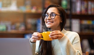 Woman with glasses drinking coffee