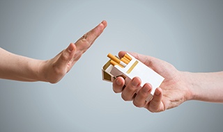 A hand refusing the offer of a cigarette
