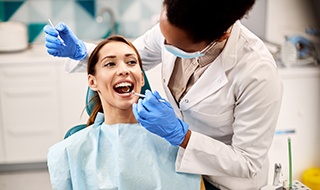 A young woman having her teeth examined at a dental checkup